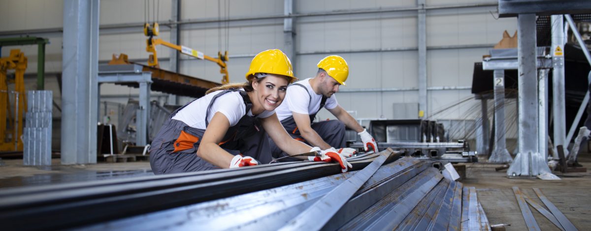Industrial workers working in factory hall with metal. Industrial workers working in factory hall with metal.